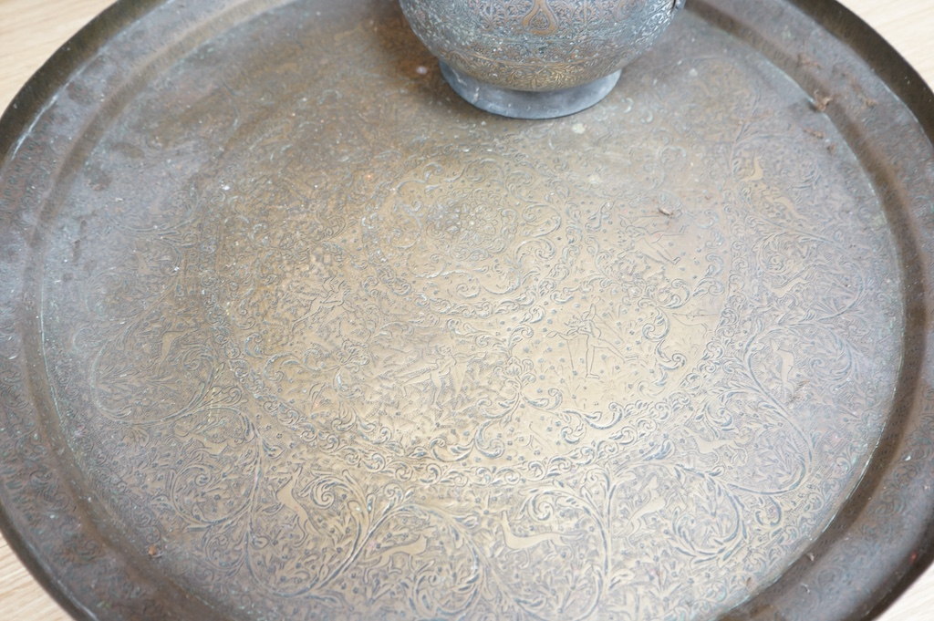 A Kashmiri brass lidded tea pot and tray, teapot 35cm high, tray 50cm diameter. Condition - fair to good